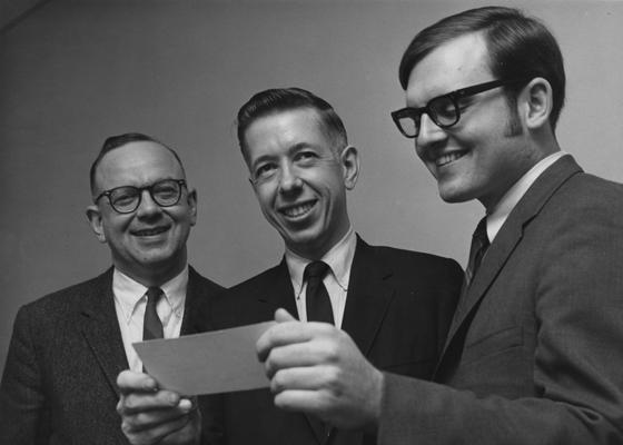 Geary, Ronald G., Alumnus, B. S. 1969, Member of Board of Trustees, 1981 - 1987, pictured (right) receiving scholarship from Dean Charles F. Haywood (left) and Raymond Roe, March 1969