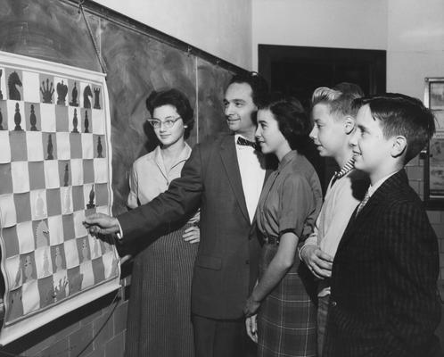 Goodman, Adolph Winkler, Professor of Mathematics and Astronomy, pictured teaching junior-high students at Morton Junior High School, from left to right are Karen Levy, Goodman, Caroline Mabry, Richard Cammack, Jim Eaves