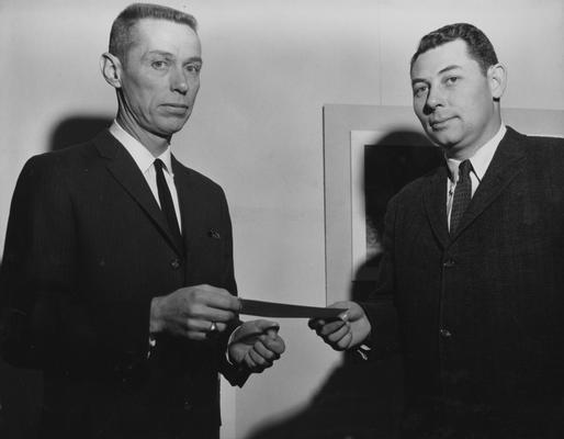 Graves, Charles P., Professor and Chair, Department of Architecture, pictured (right) receiving scholarship grant, to aid graduate students, from Lee Potter Smith, a Paducah architect, February 1961