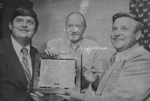 Hall, Harold L., Coordinator of Administrative Systems Planning, Executive Vice President and Past President of the Central Kentucky Association for systems management recieving the Achievement Award from Ron Bridges, center, representing the International Association of Systems Management. At left is Allen Weterfield, President of the Central Kentucky Association
