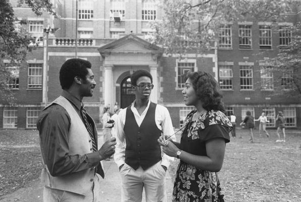Hanley, Alvin C., Director of Minority and Disadvantaged Recruitment talks with two students (Curtis Roberts and Vivian Lasley-Bibbs) outside of Frankfort High School, Frankfort, Ky