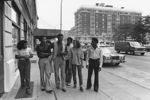 Hanley, Alvin, C., Director of Minority and Disadvantaged Recruitment walks down a Louisville street with six Valley High School Students