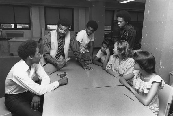Hanley, Alvin, C., Director of Minority and Disadvantaged Recruitment talks with a six African American high school students in Louisville