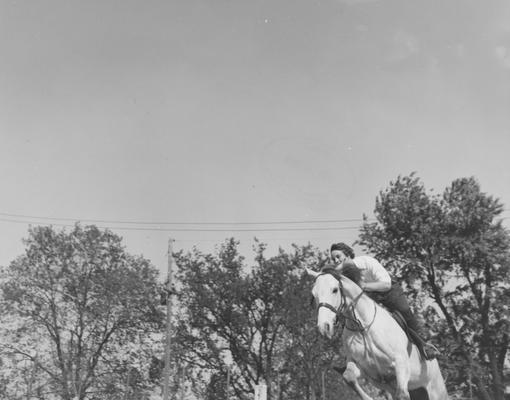 Harper, Barbara, A student in the University of Kentucky College of Agriculture and Home Economics, practices for the hunter and jumper class of the Block and Bridle Horse Show, Public Relations Department