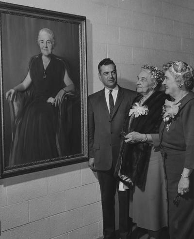 Holmes, Sarah Bennett, born 1886, University of Kentucky Dean of Women 1944-1957, From Left to right: President Fank Dickey, Sarah B. Holmes and Cleo Dawson Smith at the dedication of Holmes Hall- a women's dormitory, looking at the picture of Sarah Holmes in lobby