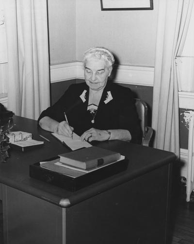 Holmes, Sarah Bennett, born 1886, University of Kentucky Dean of Women 1944-1957, seated at her desk
