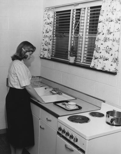 Johnson, Nancy (Mrs. Ben), 1959 alumna in a Shawneetown Apartment, Public Relations Department