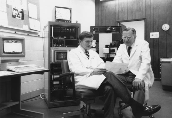 Markesbery, William R., Director of Sanders Brown Research on Aging, pictured with Ehmann, William D., Professor, Chemistry Department