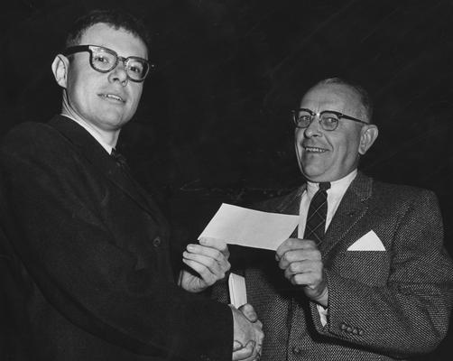 McCann, John M., a senior in Mechanical Engineering at the University of Kentucky (left), of Frankfort, receiving the Harry E. Bullock, Jr. Memorial Fund Award from Dean R. E. Shaver of the College of Engineering, from Public Relations Department