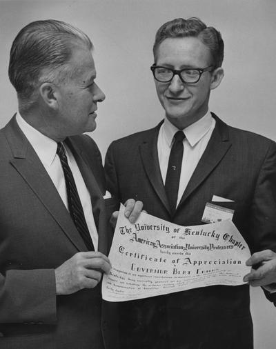 Milam, Carl Max, Assistant Professor of Political Science, pictured on right giving Certificate of Appreciation to Bert Combs (Governor)