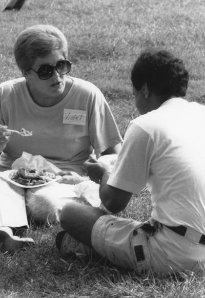 Moguson, Violet, pictured eating outside with an unidentified man