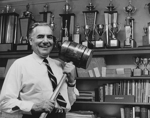 Blyton, Gifford, Professor, Speech Department, Coach of the Debate Team, 1948 - 1969, here posing with trophies
