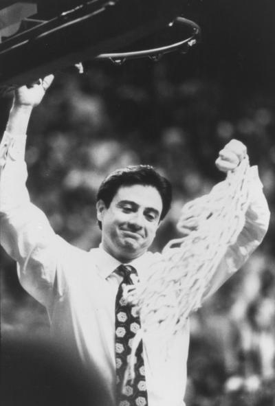 Pitino, Rick, Head basketball coach for the University of Kentucky basketball team, pictured cutting down the net after the wildcats finish first in the 1990-1991 Southeastern Conference regular season