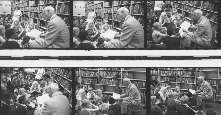 Robbins, Earl G., pictured reading to children