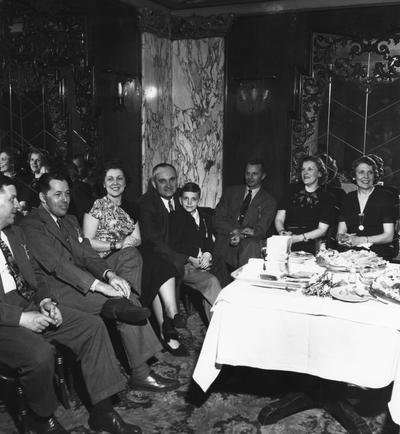 Rupp, Adolph, University of Kentucky Basketball Coach 1930-1971, pictured fourth from left with son Herky at party honoring Rupp
