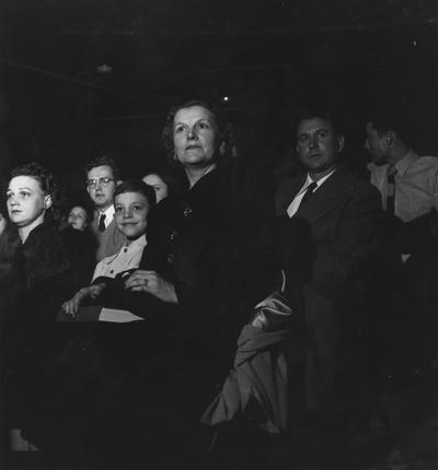 Rupp, Adolph, University of Kentucky Basketball Coach 1930-1971, from right, Mrs. Adloph Rupp and son Herky at basketball game