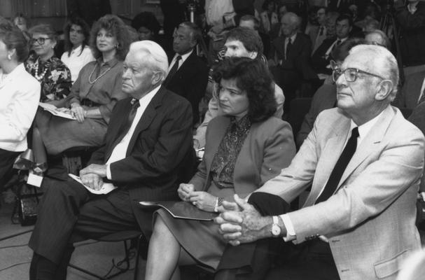 Singletary, Otis A., University of Kentucky President 1969-1987, pictured on right seated in a crowd with former Governor Bert Combs and Mrs. Combs (Judge Sara W. Combs)
