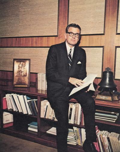 Singletary, Otis A., University of Kentucky President 1969-1987, pictured seated at credenza in his office, from Singletary papers