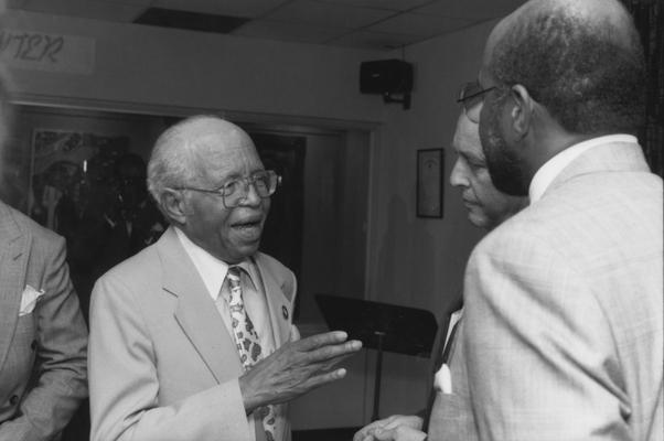Spencer, John, in the staff publication Communi-K pictured talking with University of Kentucky President Charles Wethington and John Harris III