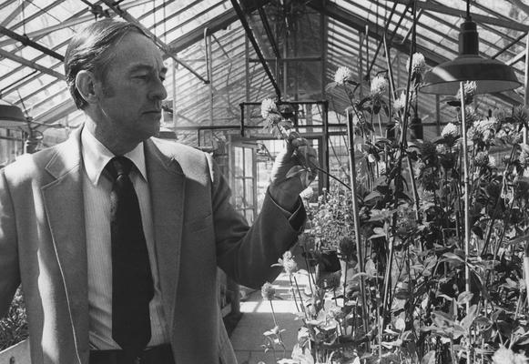 Taylor, Norman L., 1949 alumnus pictured in Greenhouse, from University Information Services