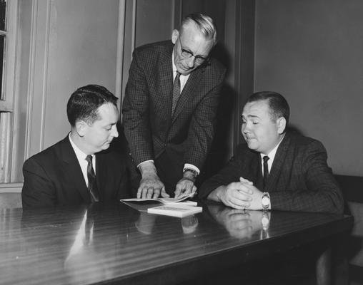 Toll, Robert, Instructor and Head of Placement Services, College of Commerce 1932-1971, pictured in the center of two men
