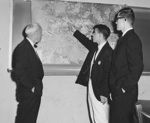 Vandenbosch, Amry, pictured looking at a map with 2 students, on left
