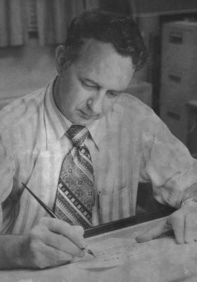 Vantreese, Clyde Thomas Jr., Assistant for Vocational Education, pictured at his desk