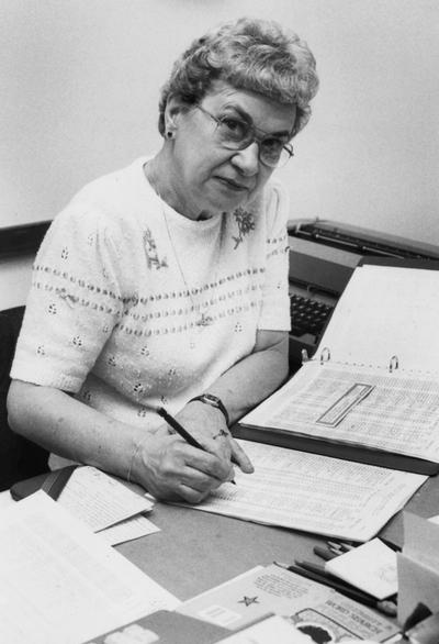 Walden, Annabel S., Teacher and Education Certification, pictured sitting at desk writing