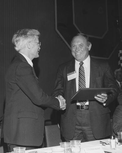 Whalen, S. J. Sam, Professor of Metallurgical Engineering, pictured on right receiving a plaque from Dean Gover, non Univeristy of Kentucky