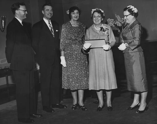 Wofford, Azile, Professor of Library Science, pictured standing with Maurince Leach, Frank Dickey, Mrs. M.M. White, and Miss Nella Bailey, for 22 years a teacher of Library Science was honored with a scholarship fund established in her name, she is attending a tea in her honor, from Public Relations Department
