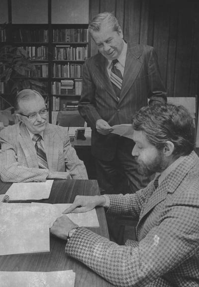 Zumwinkle, Robert, Vice President of Student Affairs, sitting at a table meeting with two unidentified men (sitting at left in glasses)