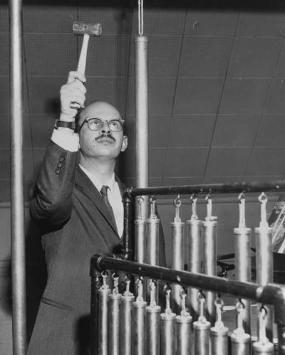 Longyear, Rey M., Musicologist, Professor, School of Music, 1964 - 1994, b. 1930 - d. 1995; Dr. Longyear playing tubular orchestra bells
