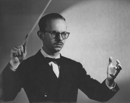 Longyear, Rey M., Musicologist, Professor, School of Music, 1964 - 1994, b. 1930 - d. 1995; posing with conductor's baton