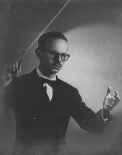 Longyear, Rey M., Musicologist, Professor, School of Music, 1964 - 1994, b. 1930 - d. 1995; posing with conductor's baton (third pose)