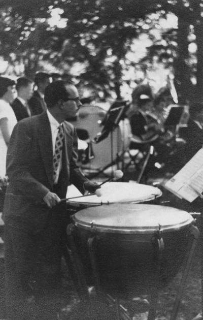 Longyear, Rey M., Musicologist, Professor, School of Music, 1964 - 1994, b. 1930 - d. 1995; playing timpani at outdoor concert