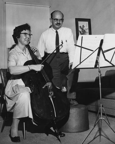 Longyear, Rey M., Musicologist, Professor, School of Music, 1964 - 1994, b. 1930 - d. 1995; pictured standing with spouse, Katherine, at the cello
