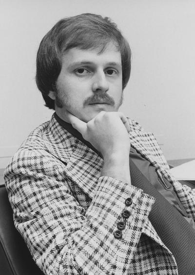 Unidentified male Medical Center employee sits at a desk