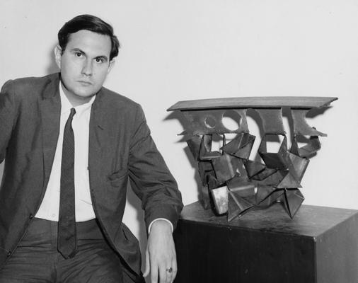 Carbonell, Galaor, 1962 alumnus pictured with sculpture