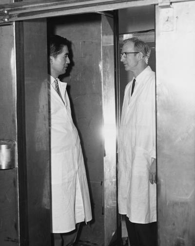 Carlson, Loren Daniel, Professor, Zoology and Physiology, pictured with unidentified man (left)