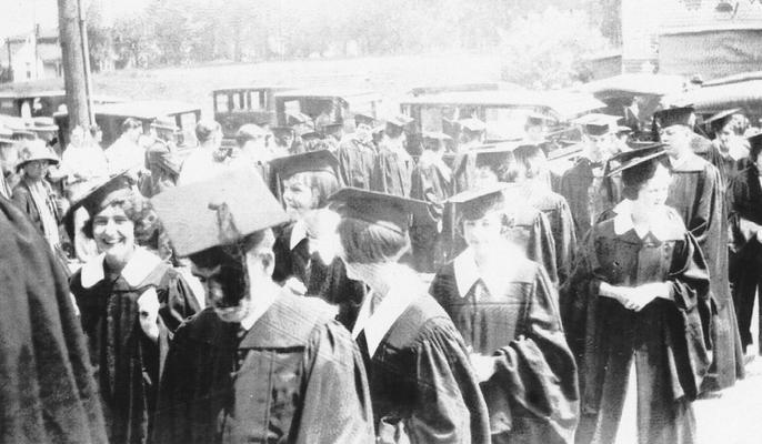 Carrol, Elizabeth (Betty), Alumna, pictured at graduation, smiling at right