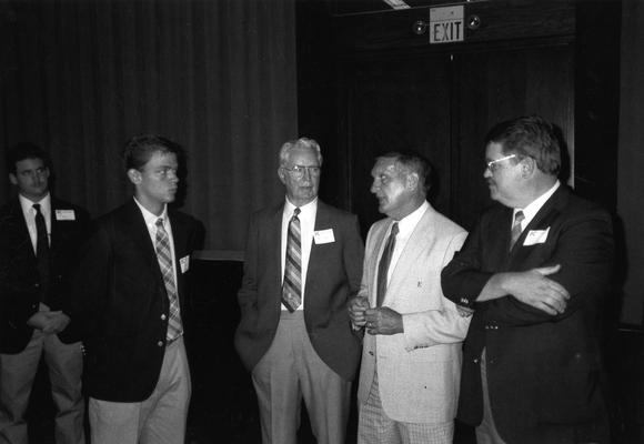 Claiborne, Jerry, Head Football Coach, 1982 - 1989, pictured at University of Kentucky Alumni Club meeting with (left to right) Todd Bergers, Lewis Bergers, Shelton Bergers