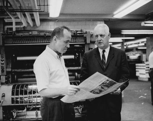 Clark, Thomas D., Alumnus, Master of Arts, 1929, Distinguished Professor, History Department, 1931 - 1968, Noted author and historian, Expert on Kentucky and Southern culture, pictured with unidentified man looking at copy from printing press, Public Relations Department