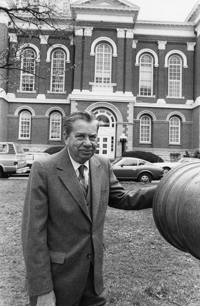 Cochran, Lewis W., Professor, Chemistry Department, Vice President for Academic Affairs, pictured with cannon in front of Administration Building