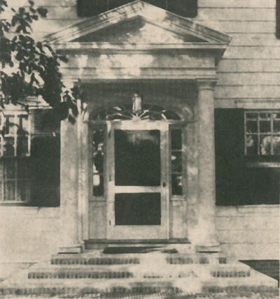An image of the entrance to a house. This image was found pasted on the back of page 101 of 