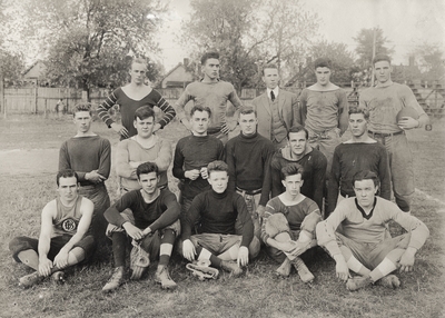 A portrait of a group of football players in a field. This image was found pasted on the back of page 104 of 