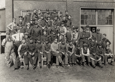 A portrait of a group of men in overalls (possibly mechanical engineers). This image was found pasted to the front fo page 105 of the 