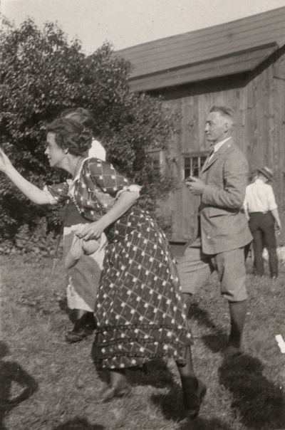 An image two men and two women outside near a barn. Margaret Ingels is in the action of throwing something. Christopher Schrader 
