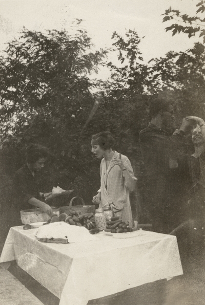 An image of Margaret Ingels, on the left, and Helen Cochran, in the center, talking and an unidentified man on the right