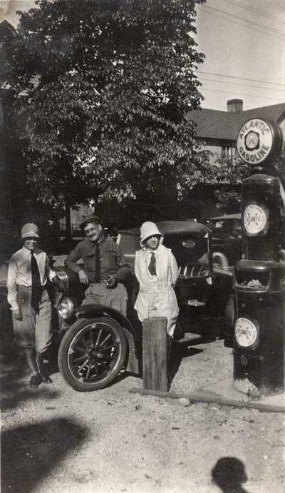 A portrait of Margaret Ingels, Mr. E. C. Evans, and Mrs. Evans standing in front of a Ford Model A, which they called 