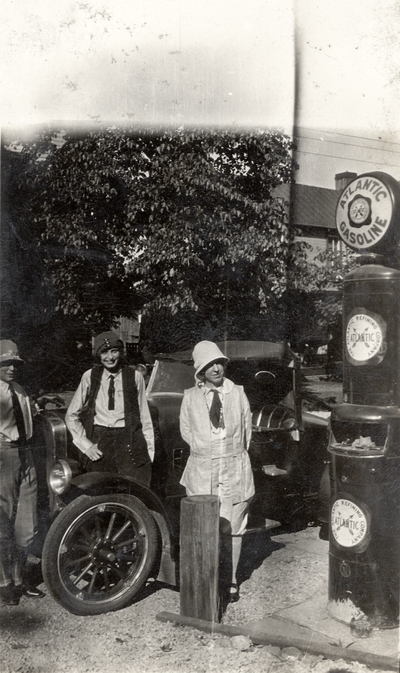 A portrait of Mrs. E. C. Evans, Helen Cochran and Margaret Ingels standing in front of a Ford Model A, which they called 